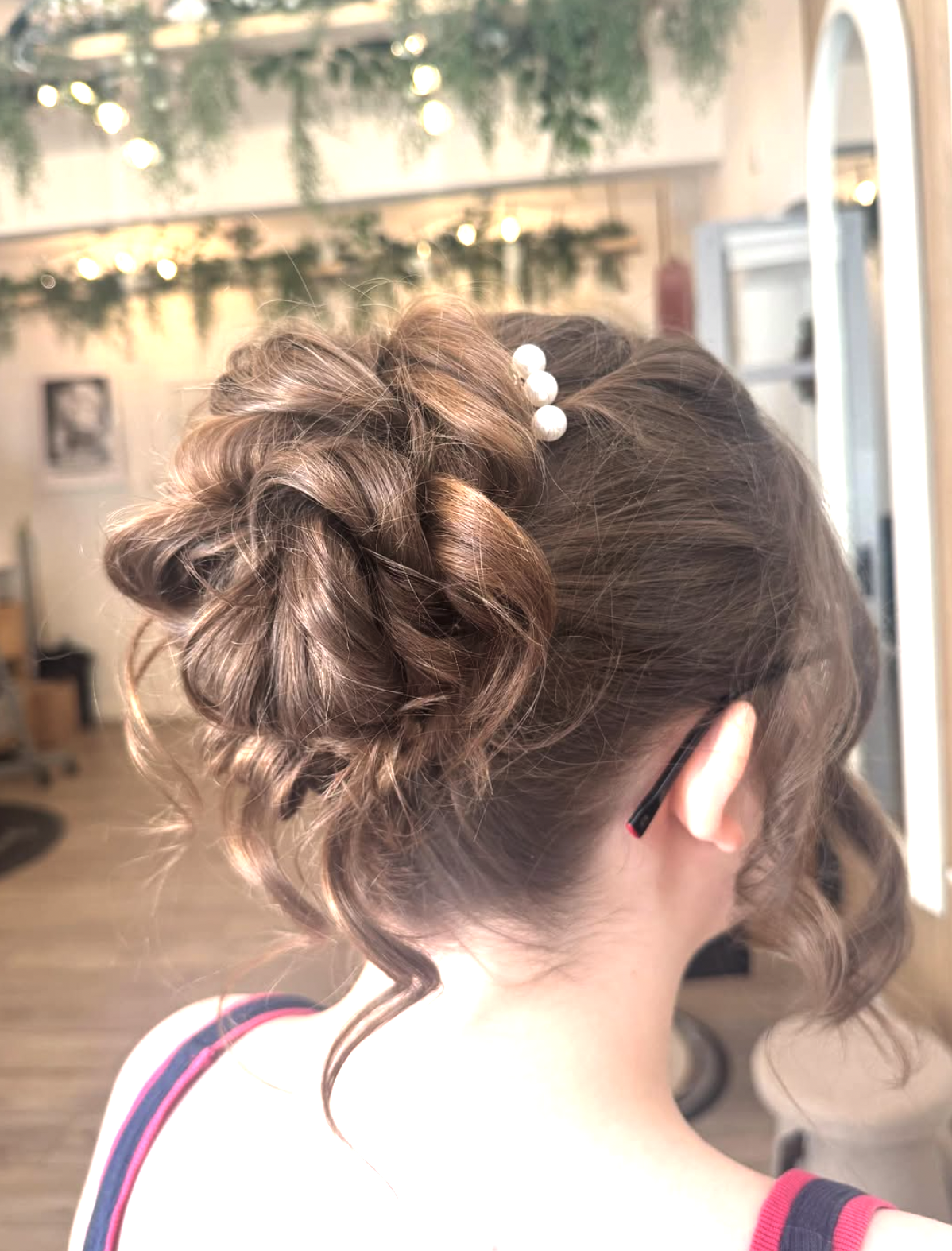 Elegant braided updo with pearl pins by Grace and Hannah at Graceful Cuts